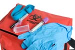 Blood drawing kit showing the biohazard transport bag, rubber, gloves, laboratory tube, tourniquet, and needle.
